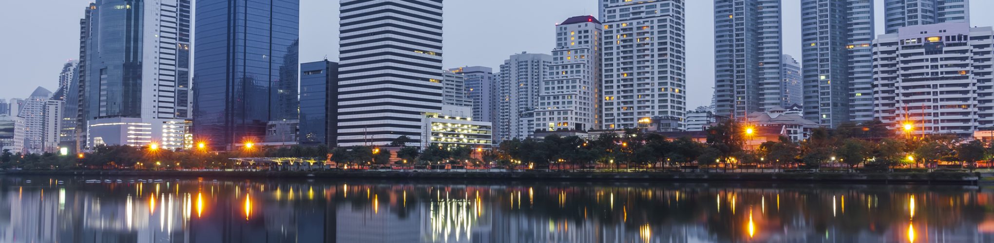 Modern office building or tower in Bangkok Thailand business center at twilight nature blue toned